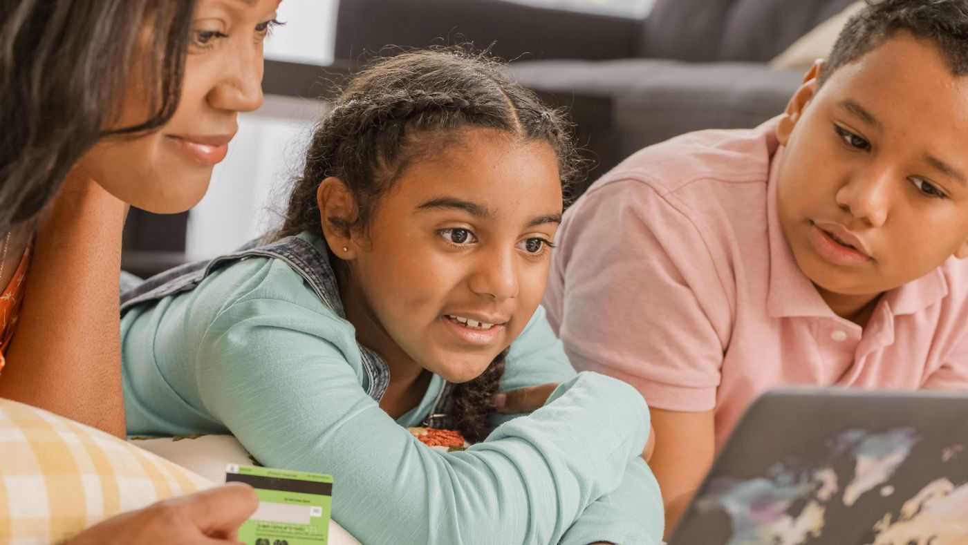 Family reviewing information together on a laptop